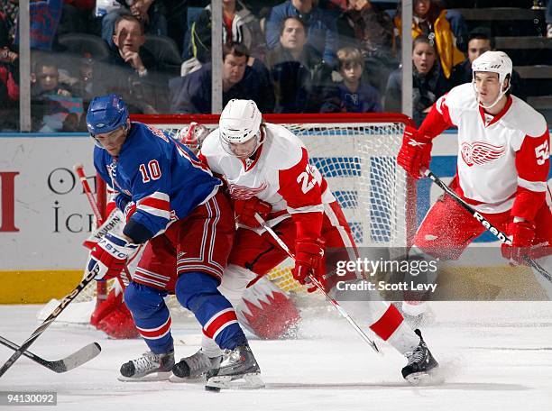 Marian Gaborik of the New York Rangers skates for the puck against Brad Stuart of the Detroit Red Wings on December 6, 2009 at Madison Square Garden...