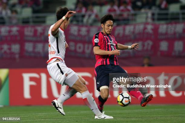 Kenyu Sugimoto of Cerezo Osaka and Oh Ban-suk of Jeju United compete for the ball during the AFC Champions League Group G match between Cerezo Osaka...
