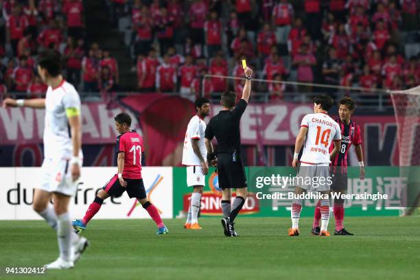 Yoichiro Kakitani of Cerezo Osaka is shown an yellow card during the AFC Champions League Group G match between Cerezo Osaka and Jeju United at Osaka...