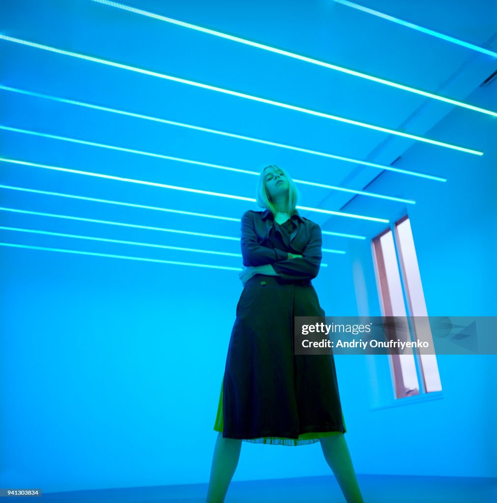 Portrait of beautiful young woman in neon light