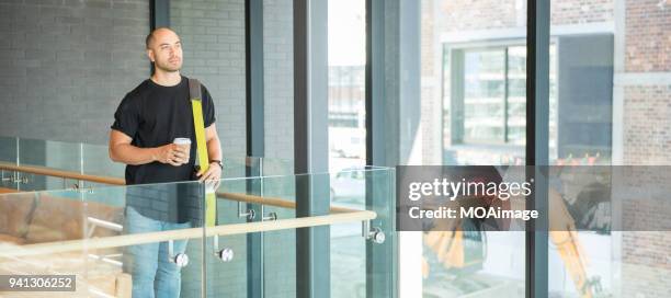 a young maori and caucasian mixed man is standing by the window - photohui17 bildbanksfoton och bilder