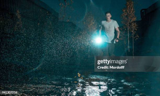 rain-soaked young man walking on roof - center of gravity 2017 stock pictures, royalty-free photos & images