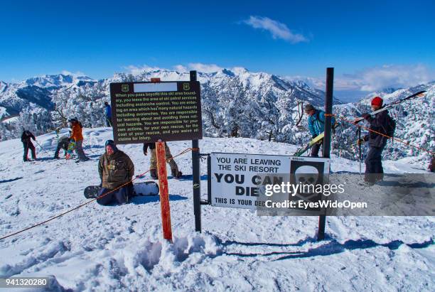 Skiers and snowboarders are passing the warning sign You can die at the ski area boundary in the Rocky Mountains on March 02, 2015 in Park City,...