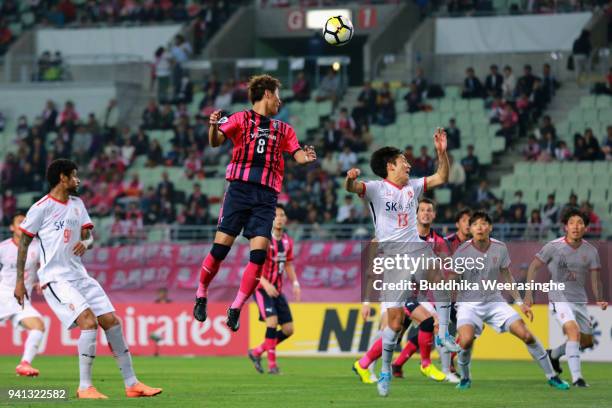 Yoichiro Kakitani of Cerezo Osaka and Chung Woon of Jeju United compete for the ball during the AFC Champions League Group G match between Cerezo...