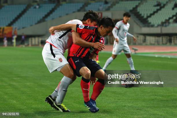 Atomu Tanaka of Cerezo Osaka controls the ball under pressure of Jung Da-hwon of Jeju United during the AFC Champions League Group G match between...