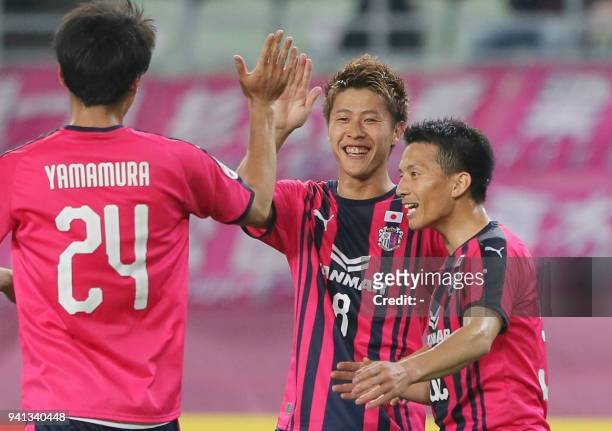 Cerezo Osaka forward Yoichiro Kakitani celebrates after scoring a goal with teammates during the AFC Champions League Group G football match between...