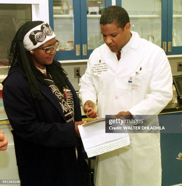 Anti-apartheid campaigner Winnie Madikizela-Mandela, the former wife of South African President Nelson Mandela, talks with Dr. Robert Thomas during a...