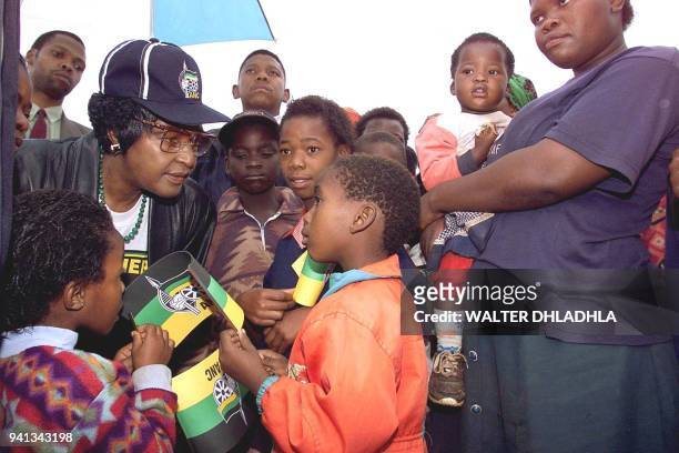 Anti-apartheid campaigner Winnie Madikizela-Mandela of the African National Congress speaks with squatter-kids, 21 April in the Mooiplats informal...