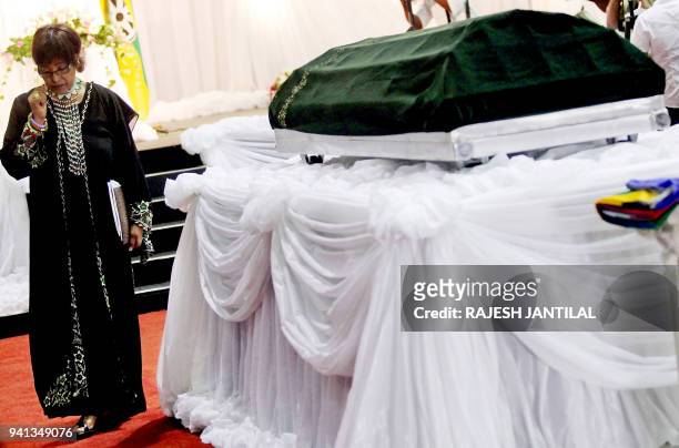 Anti-apartheid campaigner Winnie Madikizela Mandela, the former wife of South African former President Nelson Mandela pays her respects beside the...