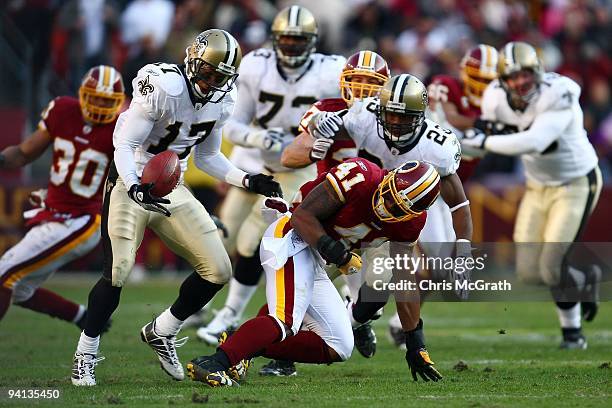 Robert Meachem of the New Orleans Saints catches a fumble by Kareem Moore of the Washington Redskins on December 6, 2009 at FedExField in Landover,...