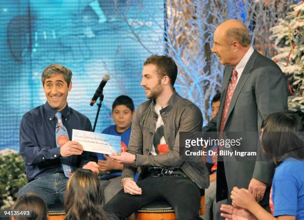 Jordan McGraw presents a check for $500.000,00 to David Wish, founder of Little Kids Rock on behalf of the Dr. Phil McGraw Foundation's and Dr. Phil...