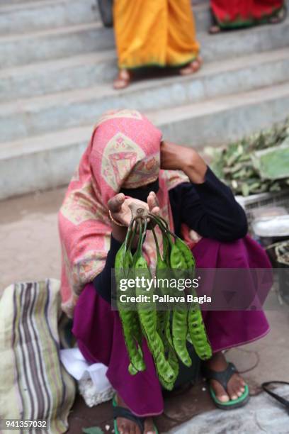 Women selling local delicacy, beans of the Parkia speciosa a tree that bears edible and much valued beans used by the locals in the cooking. A single...