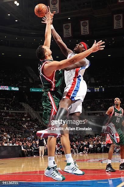 Kwame Brown of the Detroit Pistons goes to the basket under pressure against Dan Gadzuric of the Milwaukee Bucks during the game on December 4, 2009...