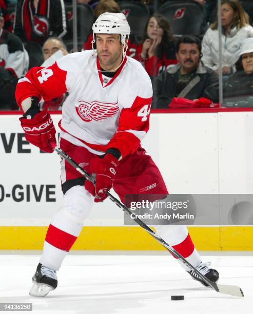 Todd Bertuzzi of the Detroit Red Wings plays the puck against the New Jersey Devils during their game at the Prudential Center on December 5, 2009 in...