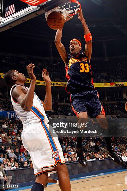 Mikki Moore of the Golden State Warriors dunks on Kevin Durant of the Oklahoma City Thunder on December 7, 2009 at the Ford Center in Oklahoma City,...