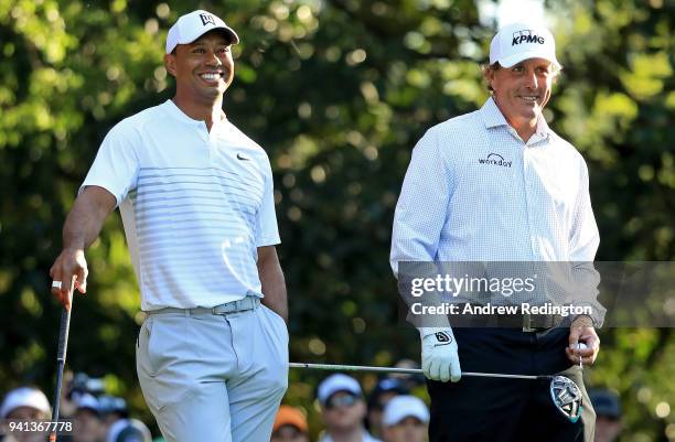 Tiger Woods and Phil Mickelson of the United States talk on the 11th hole during a practice round prior to the start of the 2018 Masters Tournament...