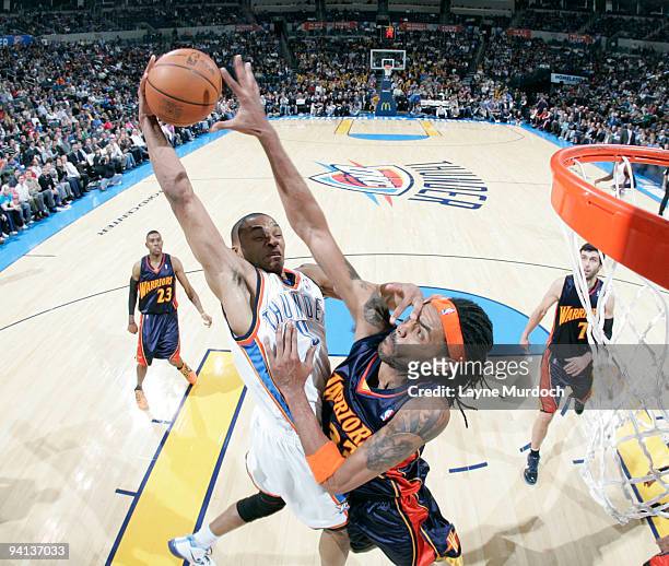 Russell Westbrook of the Oklahoma City Thunder has is shot blocked by Mikki Moore of the Golden State Warriors on December 7, 2009 at the Ford Center...