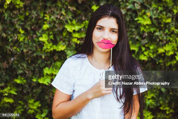 girl wearing lipstick prop on her face. - nazar abbas foto e immagini stock