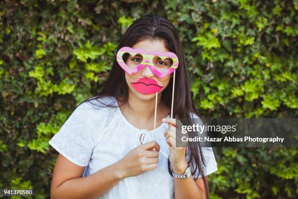 girl with props on her face. - nazar abbas foto e immagini stock