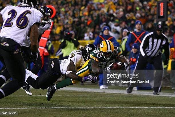 Donald Driver of the Green Bay Packers dives for an 8-yard touchdown reception in the second quarter against Lardarius Webb of the Baltimore Ravens...