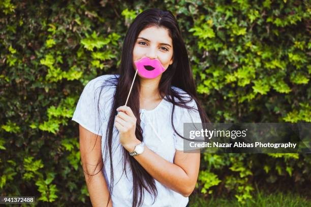 girl wearing lipstick prop on her face. - nazar abbas foto e immagini stock