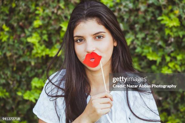 girl wearing lipstick prop on her face. - nazar abbas foto e immagini stock