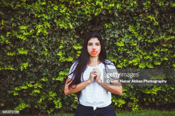 girl wearing lipstick prop on her face. - nazar abbas foto e immagini stock