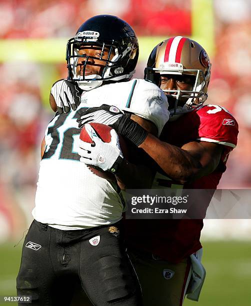 Maurice Jones-Drew of the Jacksonville Jaguars is tackled by Michael Lewis of the San Francisco 49ers at Candlestick Park on November 29, 2009 in San...