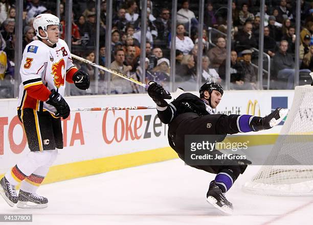 Dion Phaneuf of the Calgary Flames interferes with Raitis Ivanans of the Los Angeles Kings in the first period at Staples Center on December 7, 2009...
