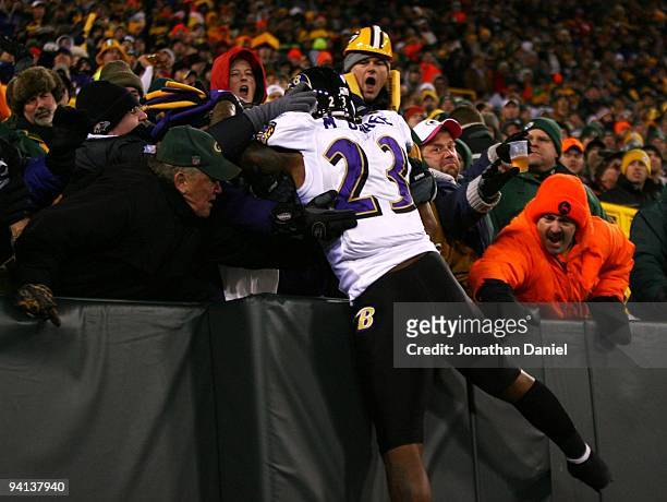 Willis McGahee of the Baltimore Ravensis pushed away by fans of the Green Bay Packers as he attempted a Lambeau leap in celebration of his 1-yard...