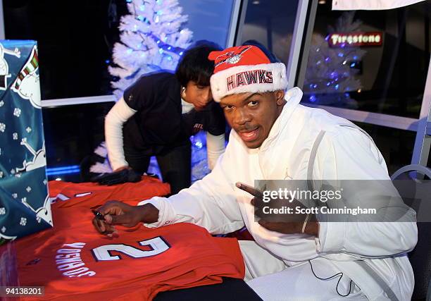 Joe Johnson of the Atlanta Hawks smiles for the camera during his annual Santa-Lanta Holiday Event at Andretti Karting & Games Center on December 7,...