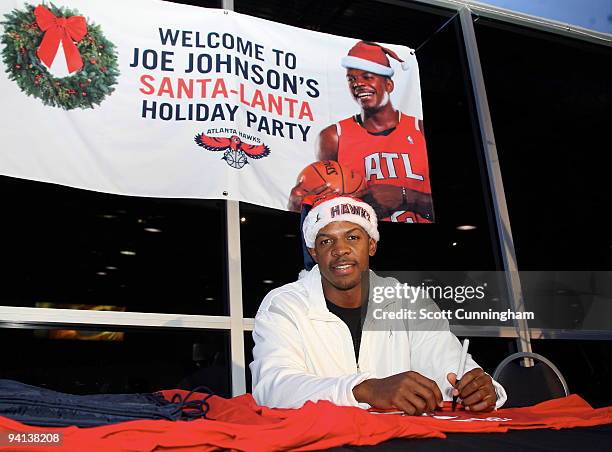 Joe Johnson of the Atlanta Hawks signs autographs at his annual Santa-Lanta Holiday Event at Andretti Karting & Games Center on December 7, 2009 in...