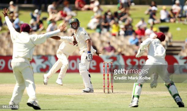 Michael Hussey of Australia looks back as he is caught behind by Denesh Ramdin off the bowling of Dwayne Bravo of the West Indies during day five of...