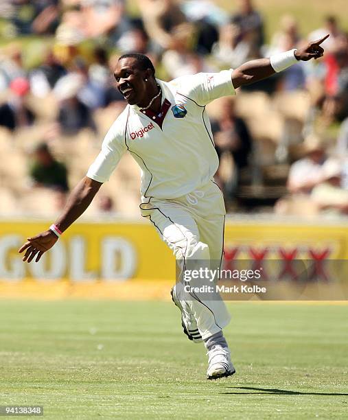 Dwayne Bravo of the West Indies celebrates taking the wicket of Michael Hussey of Australia during day five of the Second Test match between...