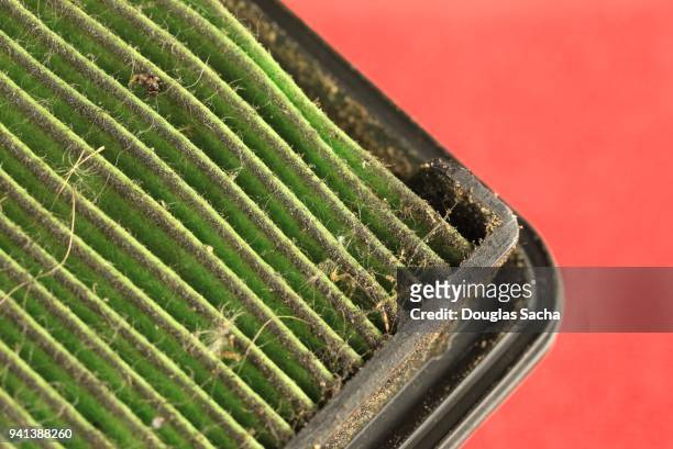 dirty air filter on a red background - pollution officer stock pictures, royalty-free photos & images