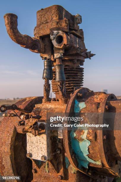 rusty broken engine against blue sky - gary colet stock pictures, royalty-free photos & images