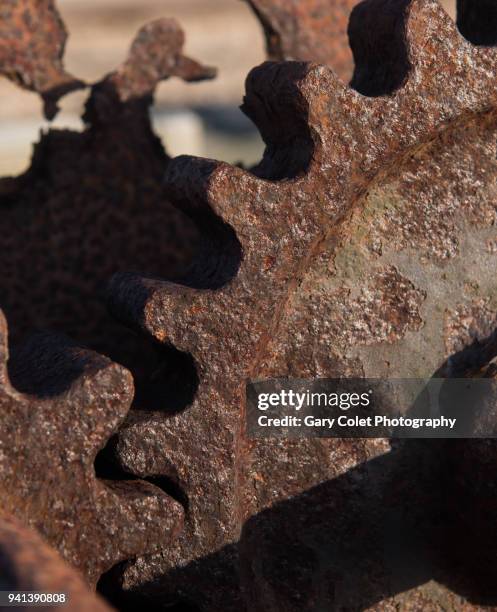 rusty gears on old beach winch - gary colet stock pictures, royalty-free photos & images