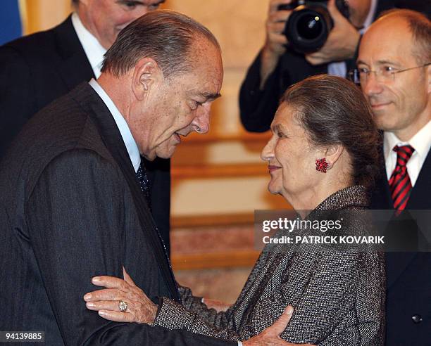 Former French president Jacques Chirac embraces former minister Simone Veil prior to awards the delegates of the Ris Orangis' MJC the Ilan Halim...