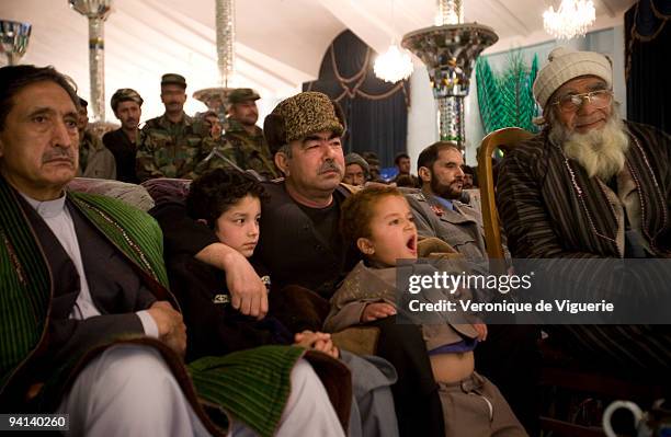 General Dostum attends a dombra concert at his palace in Sheberghan, Afghanistan. Closest to him are the two sons of one of his men who was killed...