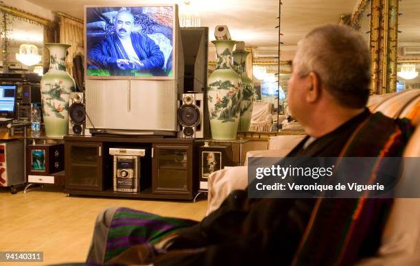 General Dostum at his palace in Kabul, Afghanistan. Here he is watching videos over and over of when he was in battle as a young and powerful warlord.