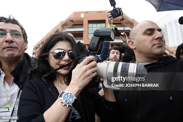 Lebanese pop star Haifa Wehbe takes pictures during the annual Beirut Marathon on December 6, 2009. AFP PHOTO/JOSEPH BARRAK