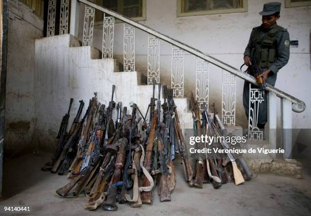 Weapons which were recovered during the Disarmament Demobilisation and Reintegration process are displayed at the police headquarters in Faryab,...