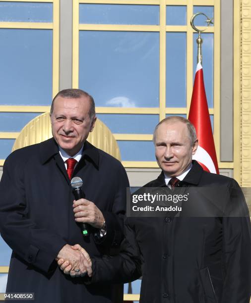 Turkish President Recep Tayyip Erdogan and Russian President Vladimir Putin shake hands as they attend the groundbreaking ceremony of Akkuyu Nuclear...