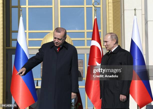 Turkish President Recep Tayyip Erdogan and Russian President Vladimir Putin shake hands as they attend the groundbreaking ceremony of Akkuyu Nuclear...