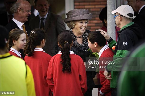 Dutch Queen Beatrix speaks to children outside of the Malburgstaete nursing home on November 17, 2009. Queen Beatrix opened the nursing home. AFP...