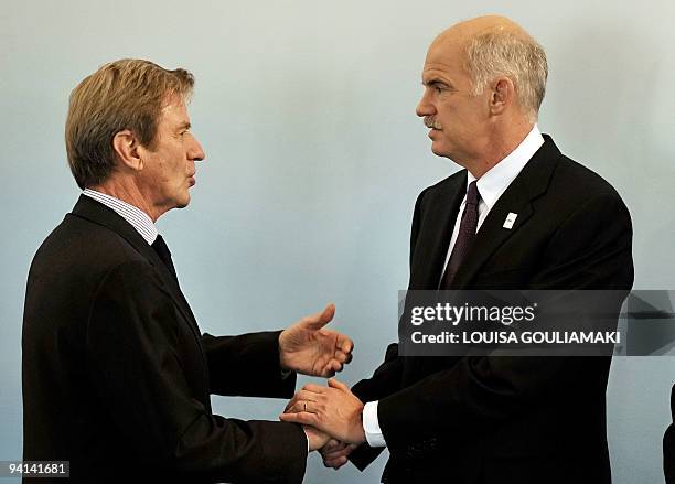 Greek Prime Minister George Papandreou talks with French Minister of Foreign Affairs Bernard Kouchner during the 17th OSCE Ministerial Council at the...