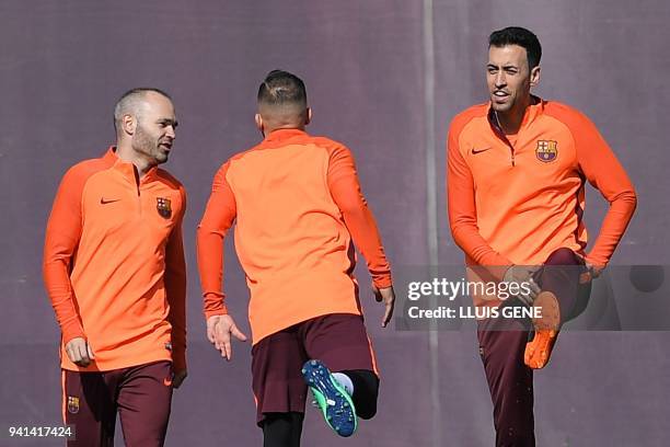 Barcelona's midfielder Andres Iniesta , Barcelona's defender Jordi Alba and Barcelona's midfielder Sergio Busquets take part in a training session at...