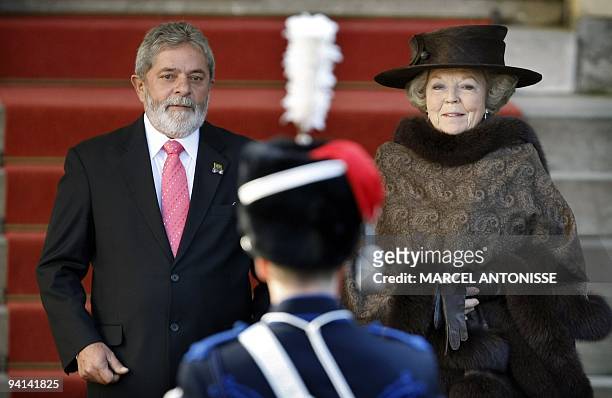 Brazilian President President Luis Inacio Lula da Silva and Dutch Queen Beatrix listen to the national anthems during the official reception at...