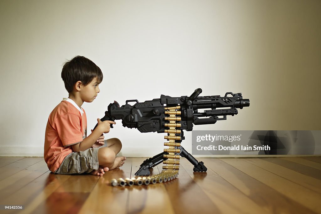 Boy with toy machine gun