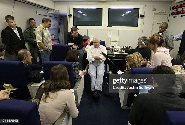 Secretary of Defense Robert Gates speaks to reporters aboard his plane December 7, 2009 while flying over the Atlantic Ocean enroute to Kabul,...